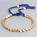 Hand-woven bracelet with irregular gold copper beads and adjustable dark blue cord - Blue