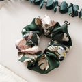 Dark green satin scrunchie with pink floral pattern on a minimalist beige background - Green with Flower