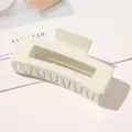 Detail of a large matte cream hair claw clip with a minimalist hollow rectangular design - 10.5cm Rectangular - Glossy Creamy Yellow