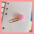 Pink fluffy pom pom gold metal paperclip bookmark on a minimalist grid notebook page - Pink Pom-pom Paperclip