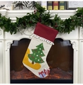 Close-up of rustic beige and red Christmas stocking with tree patch on a festive mantel - Christmas Tree