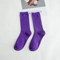 Single pair of purple ribbed cotton mid-calf socks presented with minimalist magazine - Purple