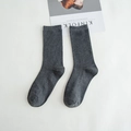 Classic grey cotton ribbed mid-calf socks presented neatly on white bedding - Dark Gray
