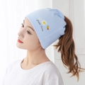Detail of light blue ponytail beanie featuring Little Daisy print and opening for hair - Bee Little Daisy / Blue