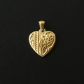 Detailed close-up of a 18K gold-plated heart pendant with floral relief on black background - M06 Floral Heart