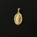 Macro shot of 18K gold plated Virgin Mary pendant with detailed embossed metal texture - M17 Oval Portrait