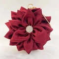 Detailed view of dark red satin floral evening bag with crystal rhinestones center - Red