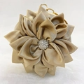 Detail of champagne satin evening bag with 3D floral petals and rhinestone center - Gold