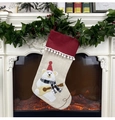 Detail of Christmas stocking with a polar bear playing guitar hanging on a fireplace - Christmas Bear Style