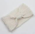 Detailed close-up of white chunky knit headband with central knot butterfly design - White