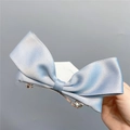 Detail of light blue satin bow hair clip featuring soft fabric texture and silver metal clip - Spring Clips / Grey Blue