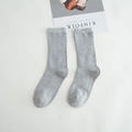 Grey ribbed cotton mid-calf socks laid flat on white background with magazine accessory - Light Gray