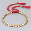 Handmade red braided cord bracelet with irregular gold beads and adjustable tassels - Red