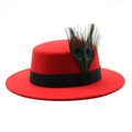 Detail of red wool felt boater hat featuring black ribbon and peacock feathers - Red