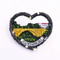 Macro shot of 3D embossed heart resin fridge magnet featuring Luxembourg city landscape - Luxembourg
