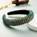 Detailed shot of emerald green crystal headband with gold chains and velvet lining - Green & Coffee