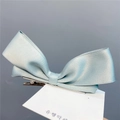Detailed view of mint green satin bow hair clip with elegant double-layered ribbon design - Duckbill Hair Clips / Mint Green