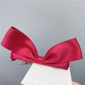 Detailed view of red ribbon bow hair clip with textured fabric and metal alligator grip - Duckbill Hair Clips / Burgundy