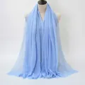 Light blue crinkled cotton linen scarf with frayed edges shown on a mannequin - Light Blue