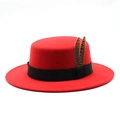 Detail of red wool felt boater hat featuring a black ribbon and two natural feathers - M (56-58cm) / Red