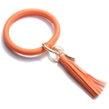 Macro detail of vibrant orange textured PU leather ring keychain with gold alloy metal clip - Orange Red