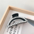 Elegant black crescent hair claw clip adorned with white pearls on wooden tray - No. 30 Semi-Circle Pearl Black