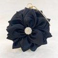 Close-up of black silk satin evening bag with 3D floral petals and rhinestone center - Black