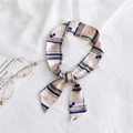 Pink silk-like scarf with blue stripes and floral patterns tied as a handbag ribbon - 17 Striped Pink Floral