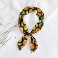 Narrow green silk scarf with orange fruit print tied in a delicate bow knot - 5 Orange Green Base