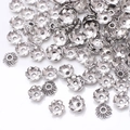 Macro shot of antique silver flower bead caps and alloy spacers for DIY jewelry making - GPHJ032