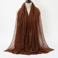 Deep brown crinkled cotton-linen scarf with natural frayed edges displayed on a mannequin - Dark Brown