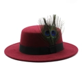 Detail of a wine red wool boater hat featuring natural peacock feathers and black ribbon - Burgundy