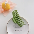 Matte forest green large shark hair claw clip displayed on a decorative white tray - Green
