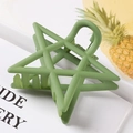 Macro shot of matte green hollow star hair claw clip on a decorative white tray - 7.5cm / Green