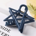 Detail of matte dark blue star hair claw clip with sturdy metal spring on white background - 7.5cm / Blue