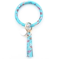 Close-up of light blue PU leather key ring bracelet with tassels and gold hardware - Happy Musical Note