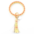 Detail of yellow baseball-style leather bangle keychain with tassel and gold hardware - Tennis Racket Yellow