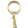 Close-up of golden PU leather bangle keychain with tassel pendant and round metal tag - Gold