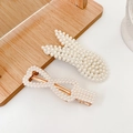 Elegant pearl hair clip set with gold bunny and bow shapes on wooden background - Floating Flute 2-Piece Set