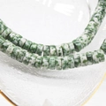 Macro detail of 6x3mm green natural stone abacus beads for DIY jewelry making - Green Dot Stone