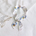 Elegant floral twilly scarf in cream with yellow flower print tied as a bow for handbags - 18 Parrot Flower