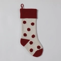 Close-up of a knitted Christmas stocking with red 3D polka dots and a hanging loop - Ivory Body / Burgundy Dots