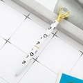 White gift ballpoint pen with black hearts, a large clear diamond top, and gold accents - White with Heart Pattern