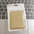 Minimalist beige PU leather phone card holder with single slot in a clear plastic package - Nappa Gold