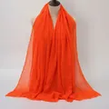 Bright orange crinkle textured cotton linen scarf with frayed edges on a mannequin - Bright Orange