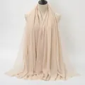 Light beige long shawl in wrinkled cotton fabric with frayed edges shown on mannequin - Light Beige