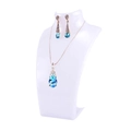 Elegant jewelry display with blue teardrop crystal necklace and matching earrings - White