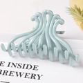 Detailed view of light blue wave hair claw clip with glossy finish and unique prong design - 10.5CM Large / Light Blue
