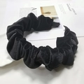 Macro detail of high-quality pleated black velvet headband texture and soft fabric finish - Black