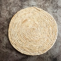Macro detail of the spiral woven texture on a natural straw round table mat - Diameter 24cm / Single Strand Corn Husk